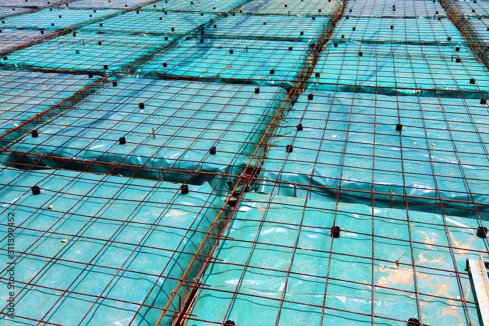 Green plastic sheeting placed beneath the reinforcing on a floating