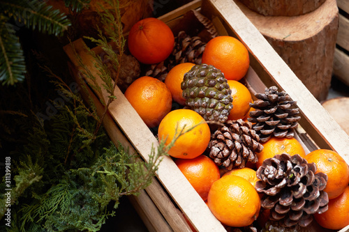 Oranges  tangerines and Christmas tree cones as New Year tree decoration