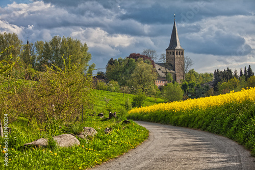 church in ratingen homberg with rapeseed and road