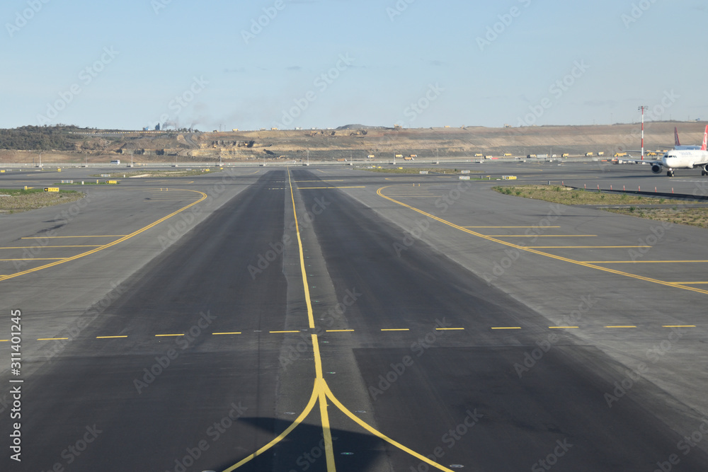 Fototapeta premium Marking for ground transportation on the airport apron among taxiways