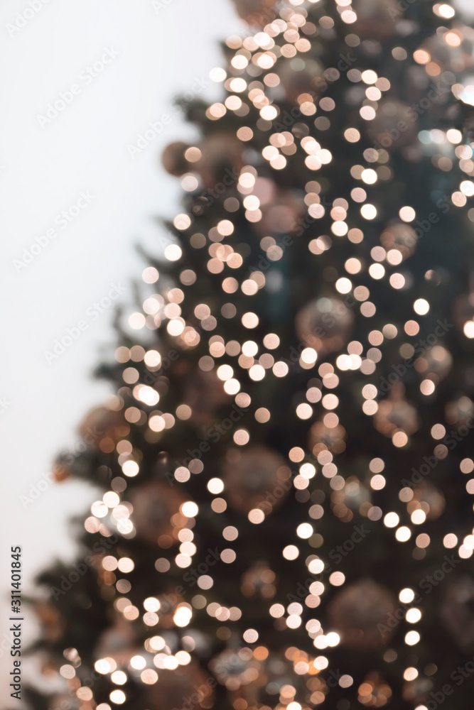 Vertical view of blurred christmas tree with garlands. Vertical view of blurred christmas tree with garlands.