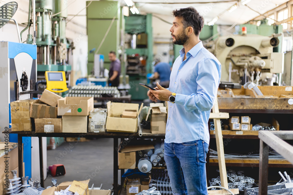 Businessman in factory. Engineer in production Businessman in factory. Engineer in production