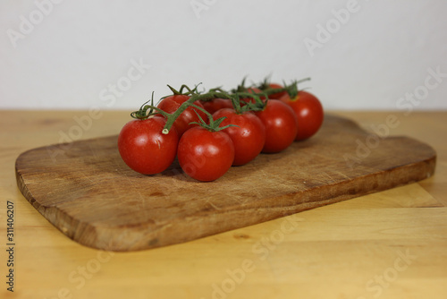 Tomatoes on a wooden plate close up