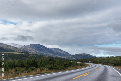 Mountains in Norway road epic scenic sky, way, clouds view. Traveling by car, driving nature tourism. Dramatic skyscape northern scandinavian sky © Kathrine Andi