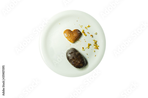 Isolate on white plate cookie heart form and other with chocolate 