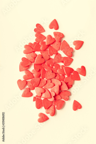 Red candy hearts on yellow background, valentine`s day background