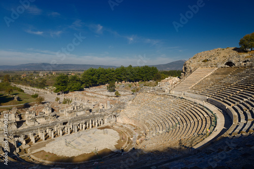 Morning sun on empty ruins of Ephesus theatre on Mount Panayir Turkey photo