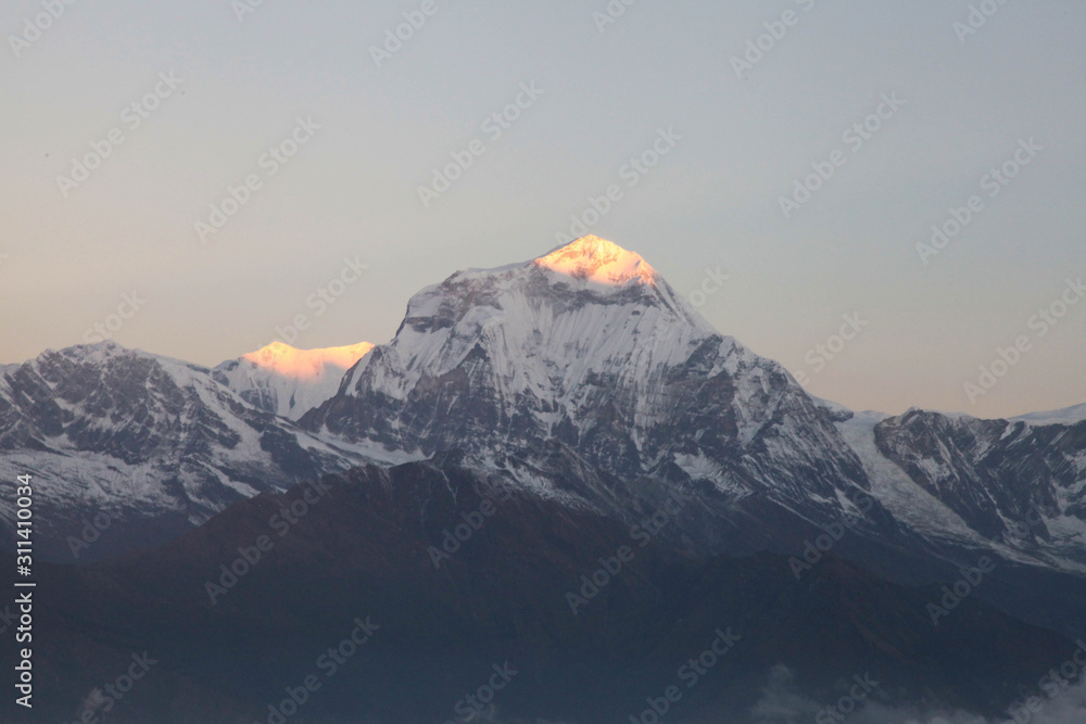 Machapuchare mountain in big white clouds. Nepal. Himalaya