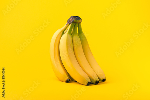 Bunch of bananas on yellow background, Healthy food concept