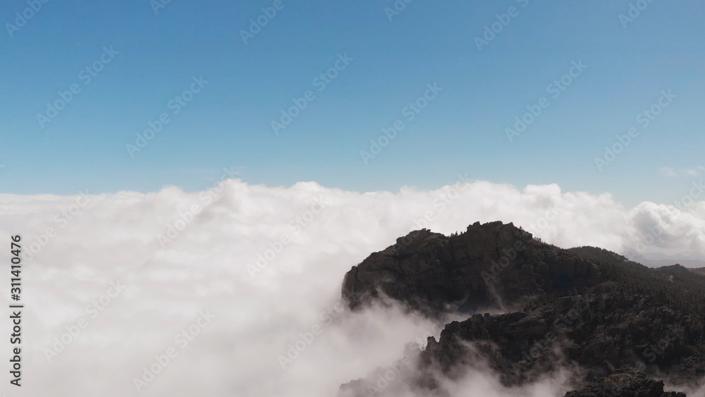 Many beautiful clouds, mountains of volcanic origin, view from a height. Pico de las Nieves, Gran Canaria