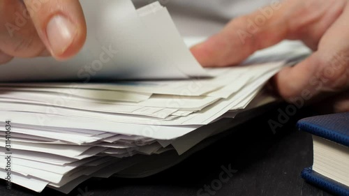 Businessman working with stacks of paper and financial report on work desk office. photo