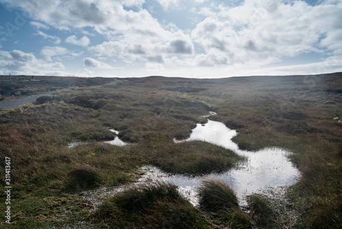 Boggy terrain and clouds in the sky at the Shetland Islands © Ineke
