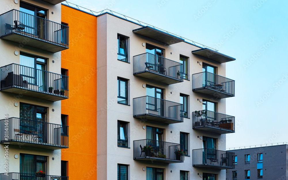 Obraz premium Apartment in residential building exterior. Housing structure at blue modern house of Europe. Rental home in city district on summer. Architecture for business property investment, Vilnius, Lithuania.