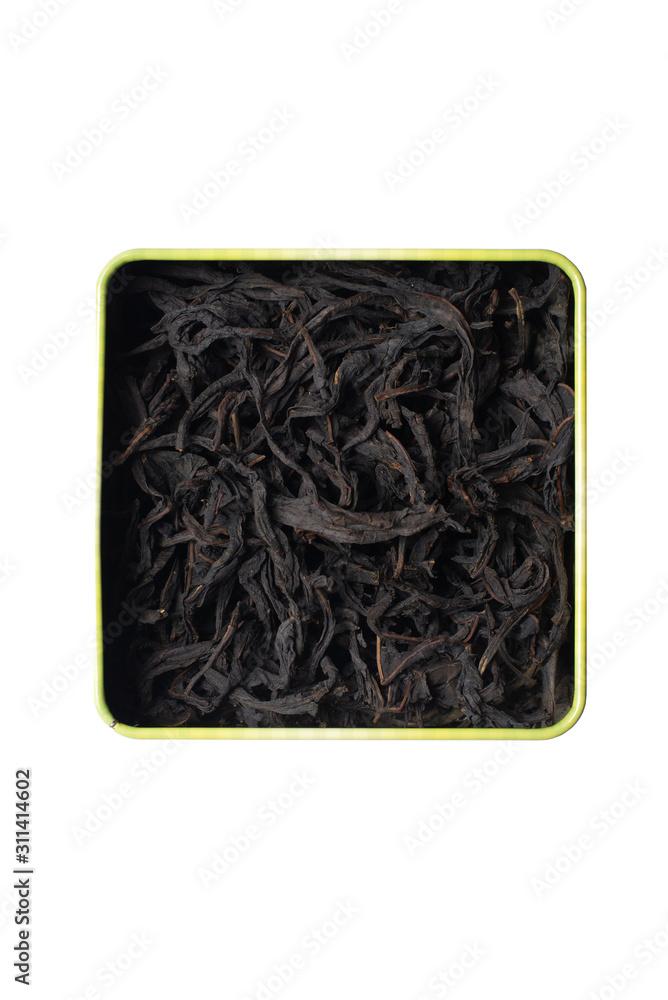 Large fermented willow-tea leaves in a square tin can. Isolate on a white background. Large fermented willow-tea leaves in a square tin can. Isolate on a white background.
