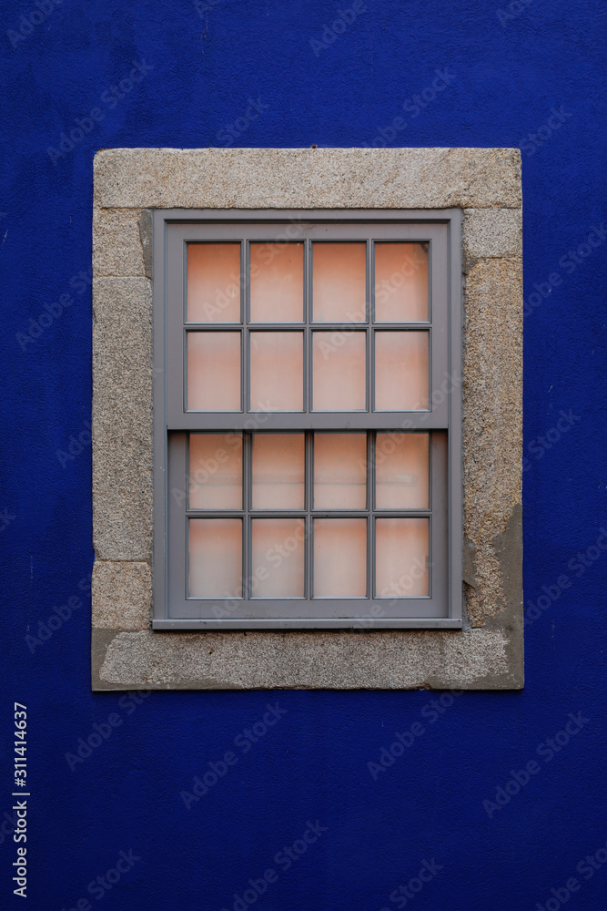 closed glass window on a blue wall with space for text and nobody