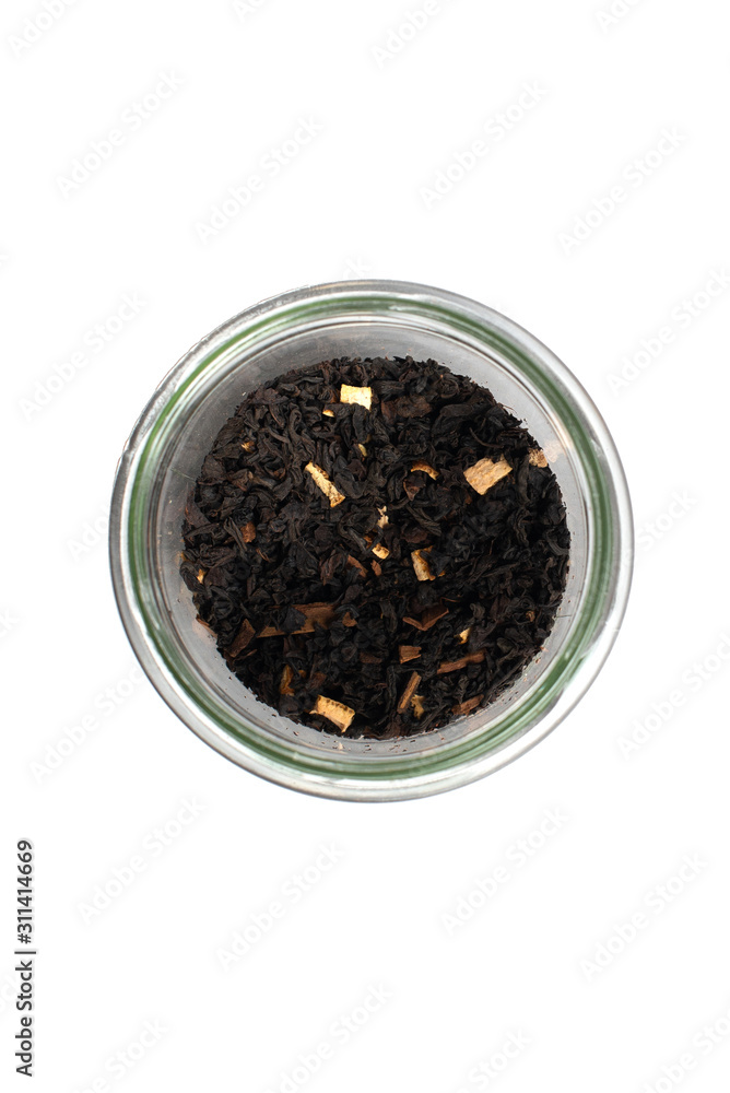 Dry leaves of black fruit tea with cinnamon and orange in a glass jar. Isolate on a white background. Dry leaves of black fruit tea with cinnamon and orange in a glass jar. Isolate on a white background.