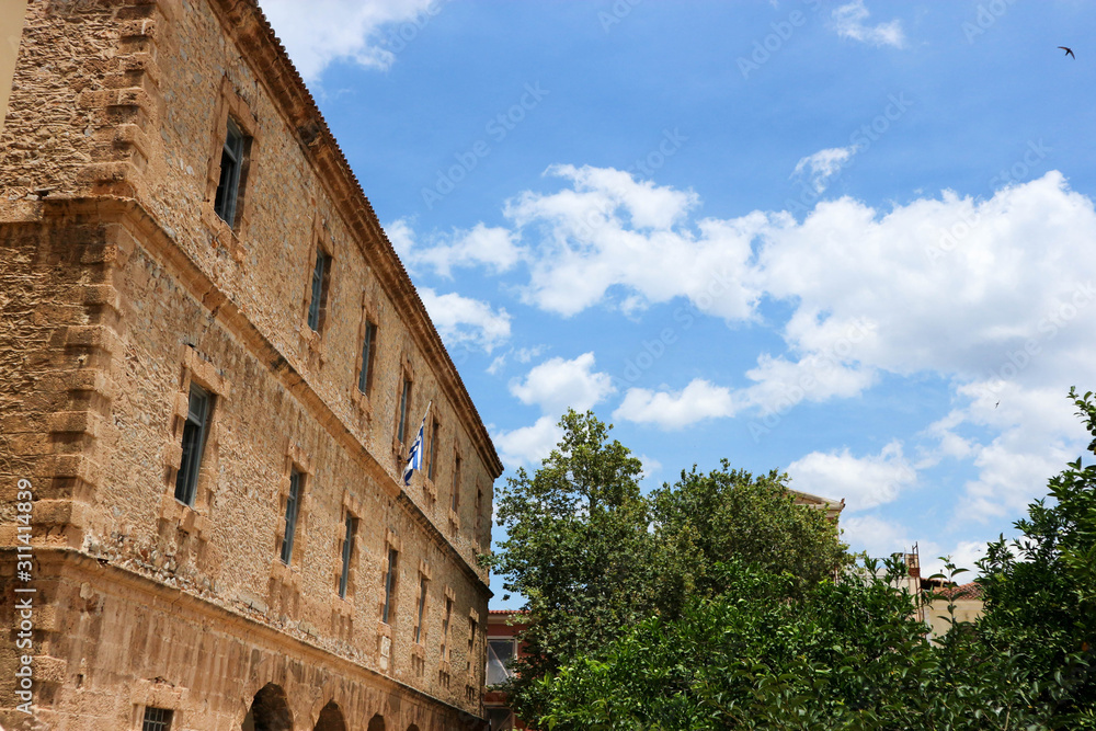 Old venetian palace in Nafplio, Greece under blue sky