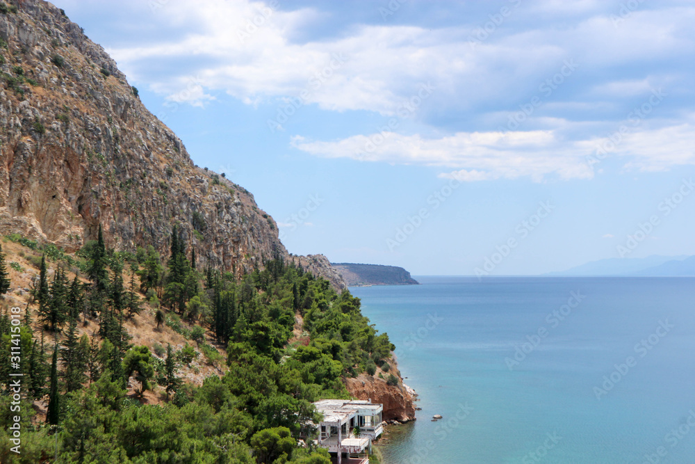 view of the boundless Mediterranean Sea and coastline with pines and rocks