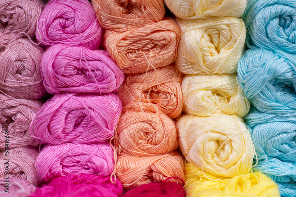 Multi-colored pink, whire, yellow, blue, white woolen threads in balls for knitting and handmade. Multi-colored pink, whire, yellow, blue, white woolen threads in balls for knitting and handmade.