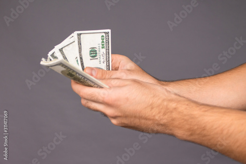 Close up of a guy handing over money for a product or service