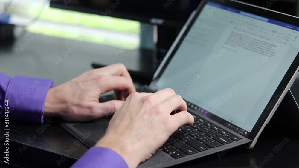 Hands typing on keyboard into a word processor Office worker making content for the job on a laptop pc Hands typing on keyboard into a word processor Office worker making content for the job on a laptop pc