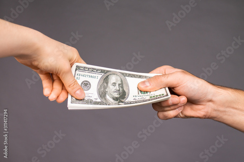 Close up of a guy handing over money for a product or service