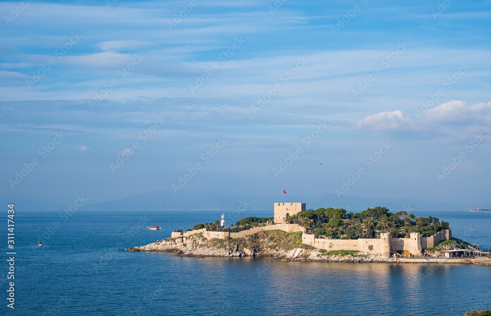 Guvercinada located in Kusadasi.  There is also a castle on the island which is built in a position protecting the harbor at the mouth of Kuşadası Gulf. High resolution photo for holiday themed works.