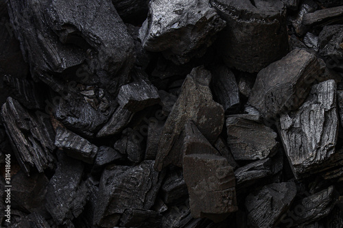 black coal background. charcoal woody black. lot of wood
