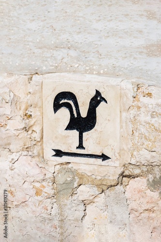 Arrow pointer with black cock on the way to Church of Saint Peter in Gallicantu, located on Mount Zion, Jerusalem, Israel photo