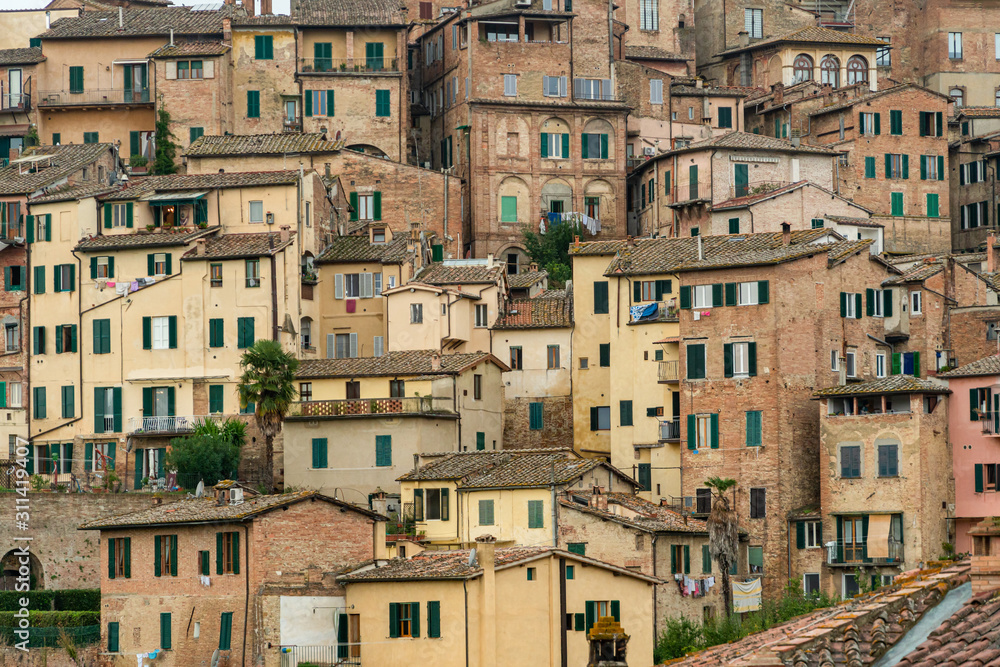 Pattern houses beackground, Old residential houses in medieval city of Siena, Italy