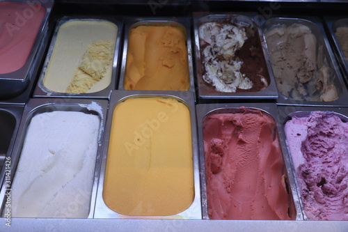 Assorted ice cream flavors in metal tubs