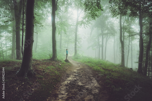 Woman resting on a walk in the spring forest