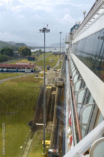 A cruise ship passes through the Panama Canal with inches to spare