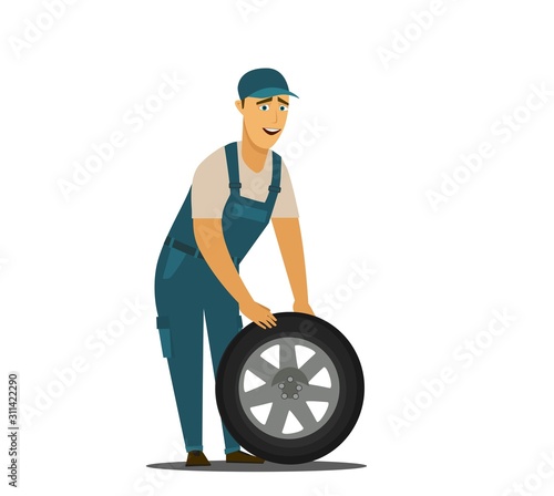 Young mechanic changing wheel at tire service