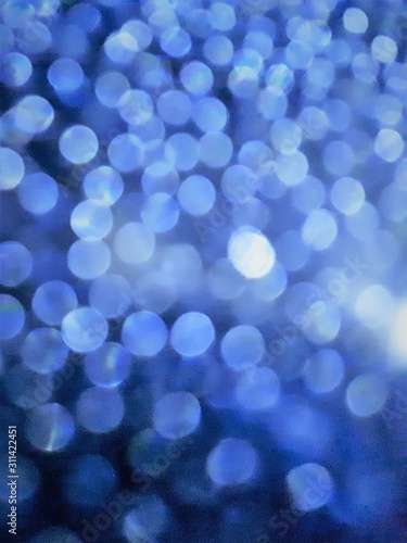  close-up of decorative abstract window surface after rain with blur / bokeh effect in classic blue color