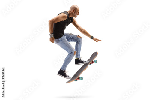 Male skateboarder jumping with a skateboard