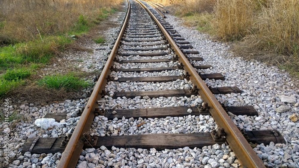 Fototapeta premium empty rail road track and white pebbles