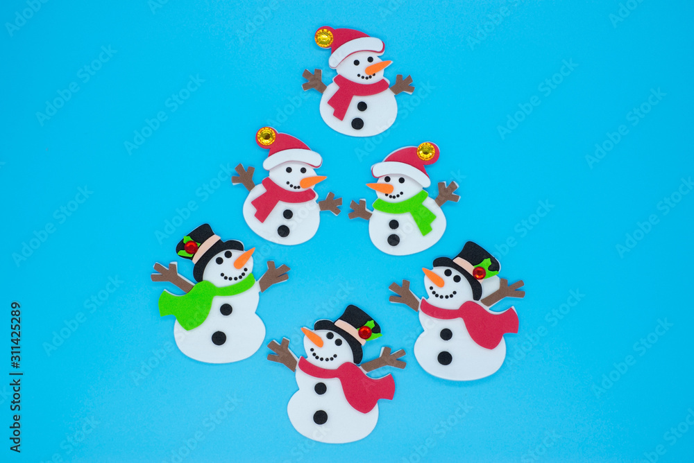 Creative Christmas tree of snowmen on a blue background Creative Christmas tree of snowmen on a blue background