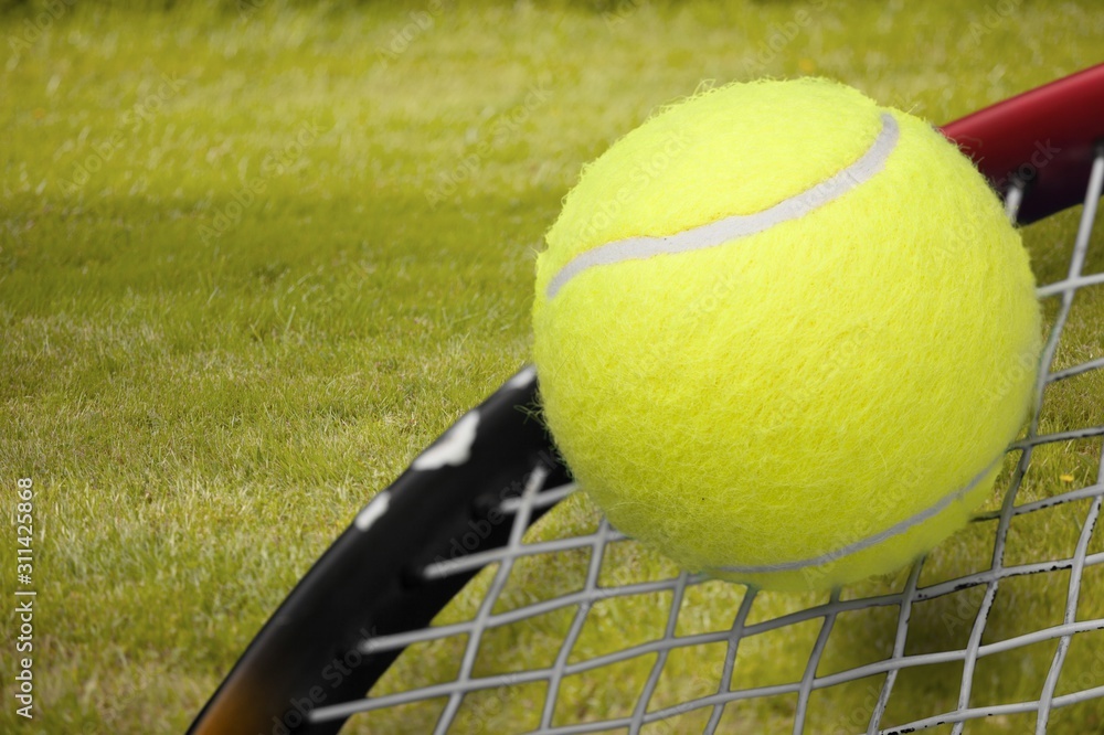 Tennis game. Tennis balls and rackets on grass