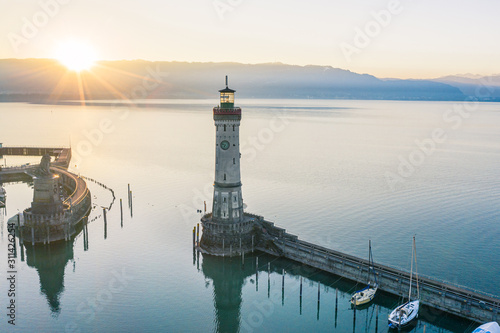 Atmospheric, high-angle view of Lindau Harbour lighthouse at sunrise, Lake Constance, Bavaria, Germany