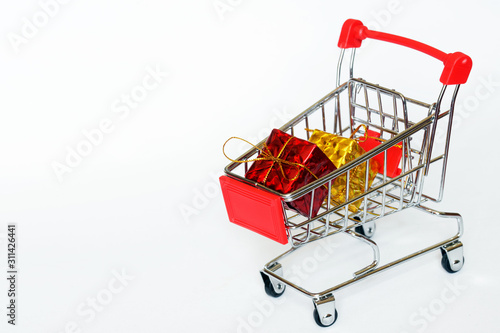 Carts from the supermarket with bright gift boxes. Seasonal and holiday sales. Gifts for birthday, New Year, Christmas and other dates. White background