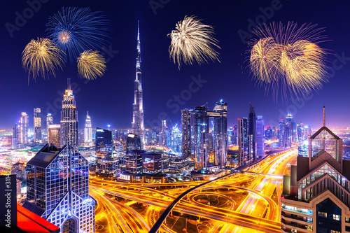 Canvas Print Amazing skyline cityscape with illuminated skyscrapers and fireworks