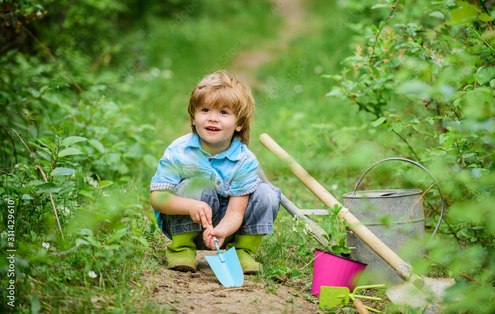 farming and agriculture cultivation. small kid gardener planting a flower. human and nature. earth day. Eco life. summer activity. happy child farmer use garden shovel, spring. Enjoying spring day farming and agriculture cultivation. small kid gardener planting a flower. human and nature. earth day. Eco life. summer activity. happy child farmer use garden shovel, spring. Enjoying spring day