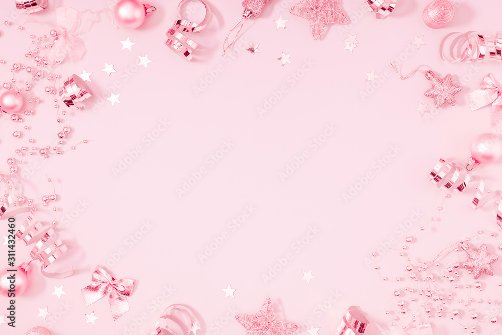 Christmas modern composition. Pink decorations, confetti, streamers, stars on light pink pastel background. Christmas, New Year, winter concept. Flat lay, top view, copy space