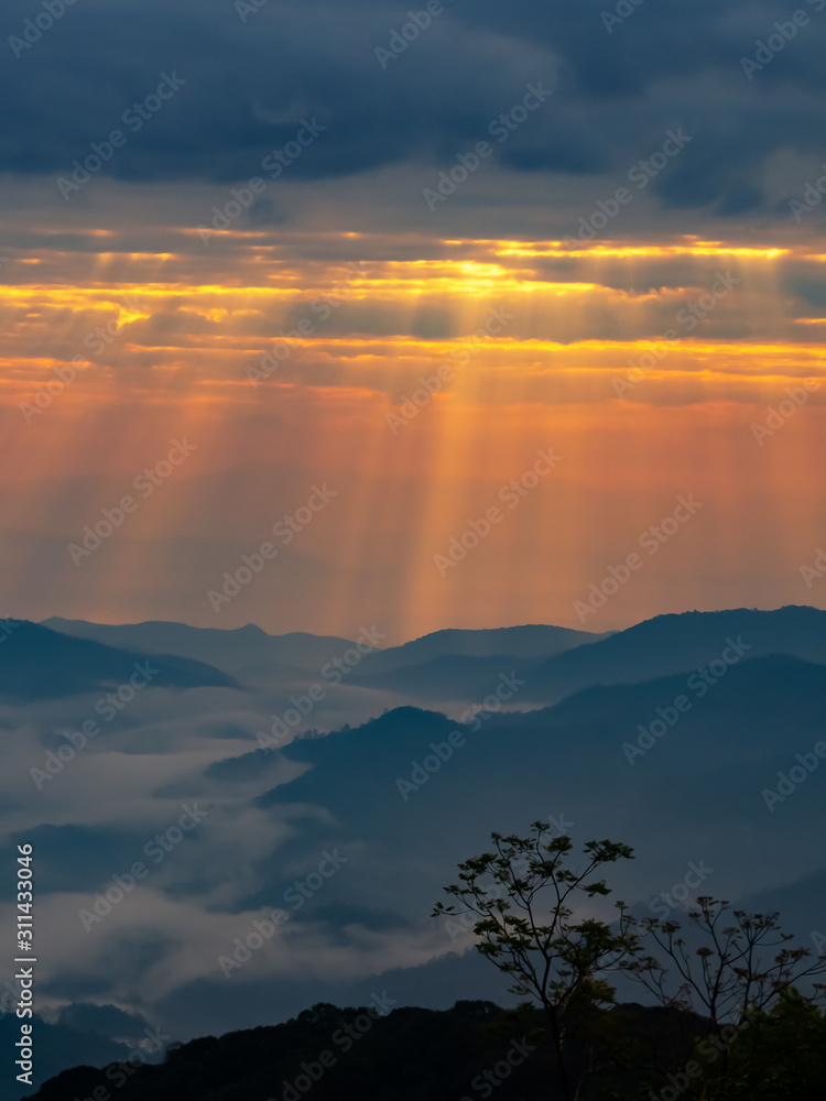 mountain landscape with colorful vivid sunset on the cloudy sky