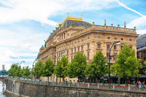 Prague embankment on a summer day. Panorama of the city. Beautiful buildings.