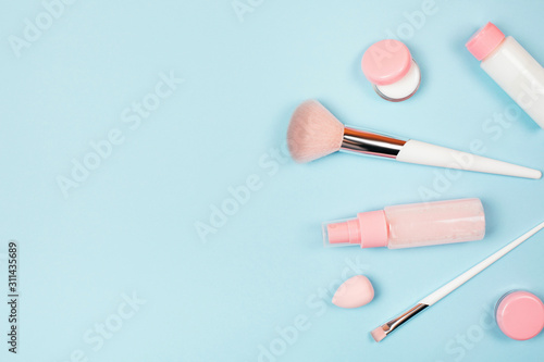 Care cosmetics in bottles on a delicate blue background.