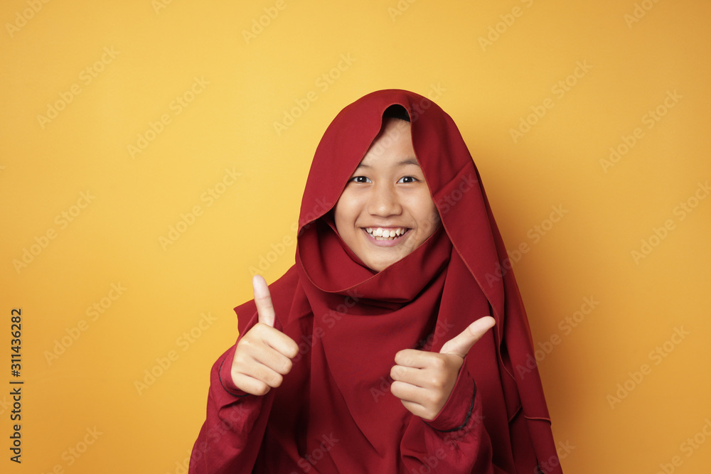 Muslim Teenage Girl Shows Thumbs Up Gesture Muslim Teenage Girl Shows Thumbs Up Gesture