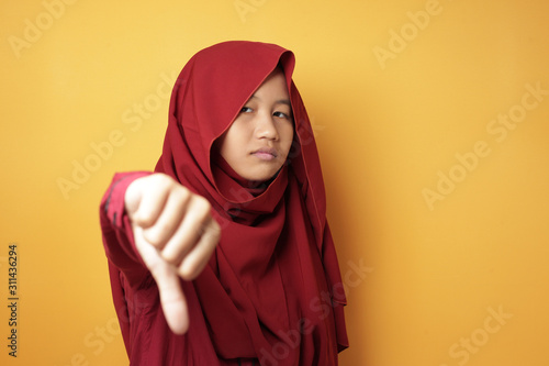 Teenage Asian Muslim Girl Shows Thumb Down Gesture © airdone
