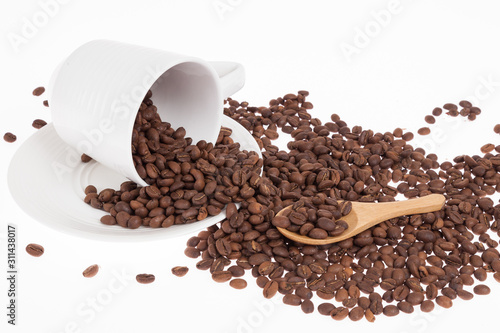 Roasted organic coffee beans - Coffea; photo on white background.